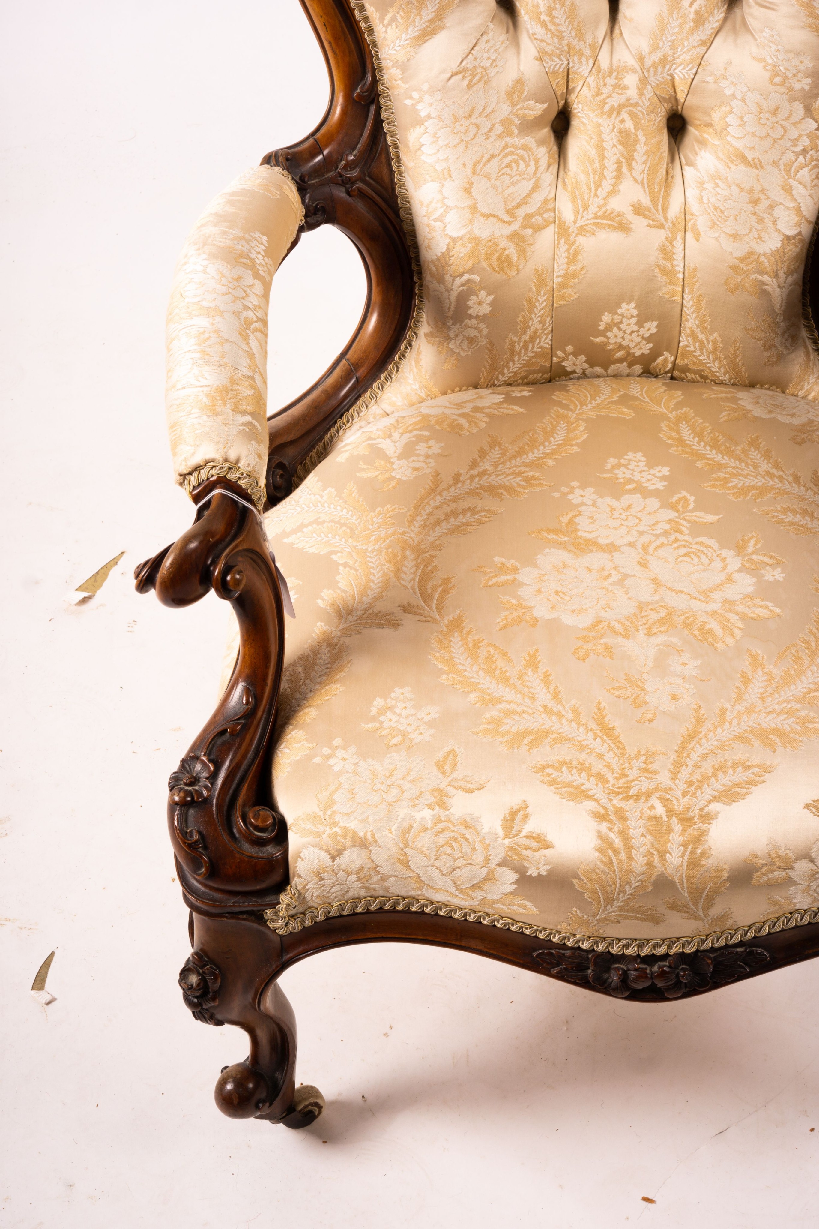 A late Victorian carved walnut three piece salon suite, comprising chaise longue, open armchair and nursing chair